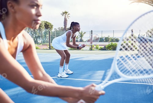 Preview: Shot of two attractive young women standing together while playing tennis
