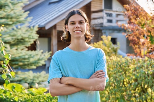 Preview: Outdoor portrait of teenage guy looking at camera