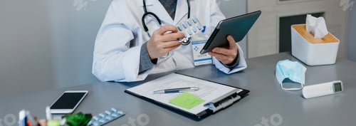 Preview: Female doctor reading drug leaflet on tablet