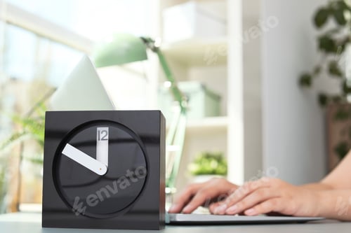 Preview: Stylish analog clock on table in office. Time to work