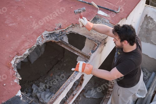 Preview: Young man pulling the roof of a house down.