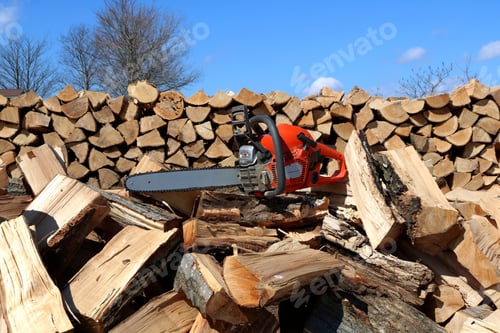 Preview: New professional chainsaw splitter and piles of firewood outdoors