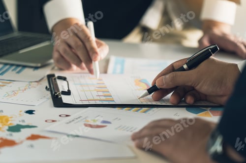 Preview: Two businessman team calculate about summary report annual on table office.