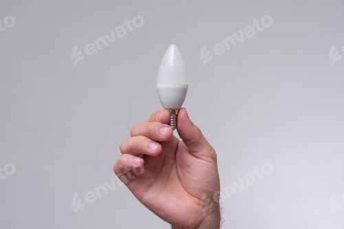 Preview: candle-shaped LED lamp in hand