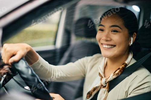 Preview: Young happy Asian woman enjoying while driving a car.