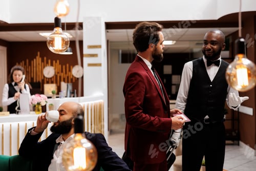 Preview: Hotel concierge assisting businessman