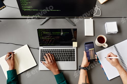Preview: Two Developers Writing Code Top View