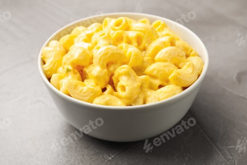 Preview: Delicious pasta with cheese sauce in bowl on grey table, closeup