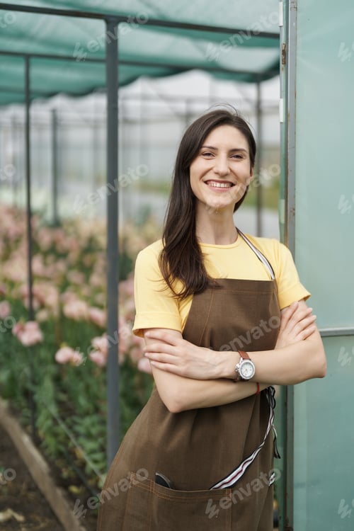 Preview: Smiling florist business woman portrait at the green house.