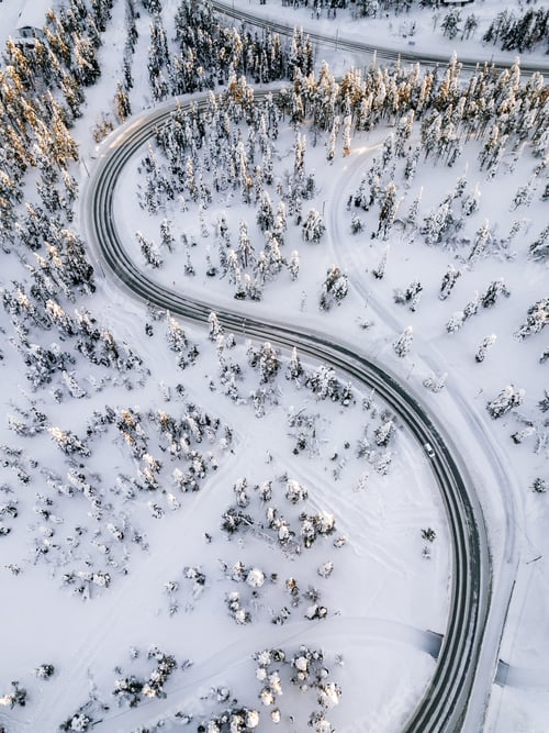 Preview: Aerial view of Curvy Windy Road in snow covered forest in Winter Finland