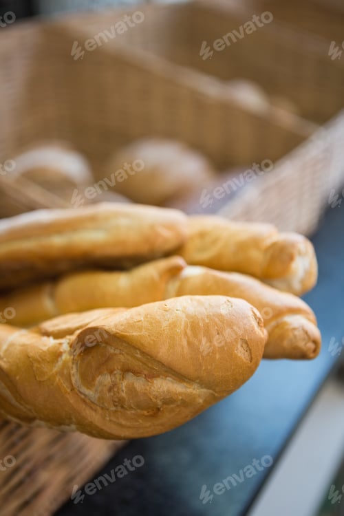Preview: Close up of basket with rustic baguettes at the bakery