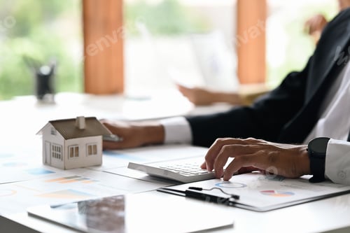 Preview: Businessman investors hand using calculator for calculating loan of finance and planning.