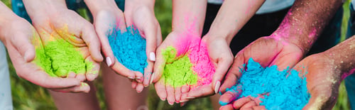 Preview: panoramic shot of multicultural friends holding colorful holi paints in hands