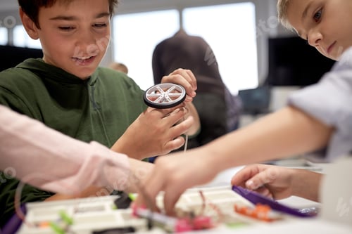 Preview: children with building kit at robotics school