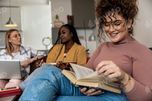 Preview: Portrait of female student learning at home with her friends.