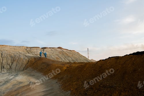 Preview: Figures of ecologists moving along hill during investigation of abandoned area