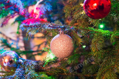 Preview: Christmas silver and red balls on Christmas tree. Indoors. Close up. Garland