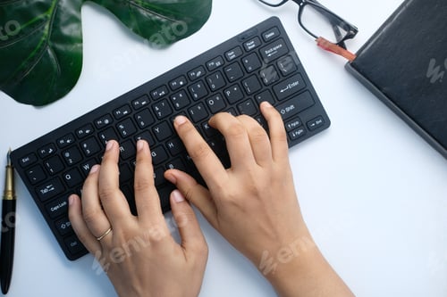 Preview: high angle view of women hand typing on keyboard