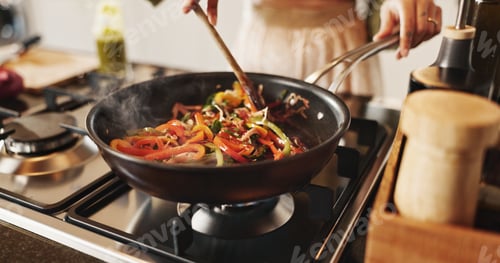 Preview: Person, cooking and pan with stir fry on stove for food, meal prep or vegetables in kitchen at home