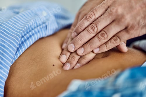 Preview: Chiropractor Performing Abdominal Therapy on Patient in Clinic Setting