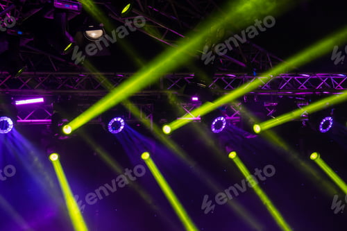 Preview: blue luminous rays from concert lighting against a dark background, musical instrument concept