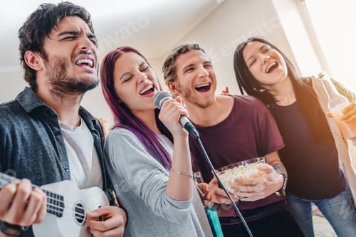 Preview: Close up group of friends playing karaoke at home
