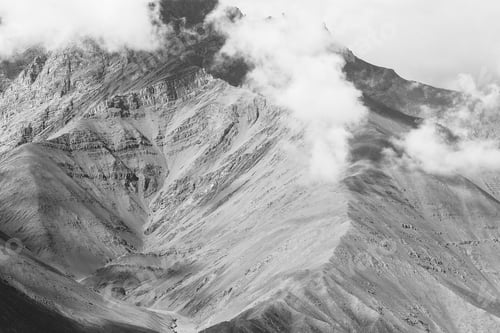 Preview: Close-up of Mountain ridge over cloud and fog in Leh, India- in black and white