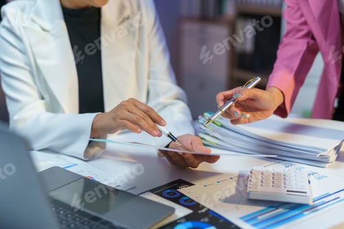 Preview: Businesswomen analyzing financial data, discussing revenue growth