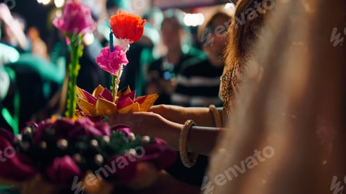 Preview: Celebrating loi krathong festival in bangkok, hands holding floral krathong offering