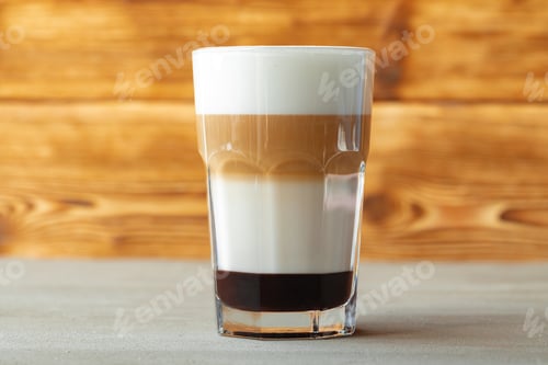 Preview: Glass of tasty aromatic latte on wooden background