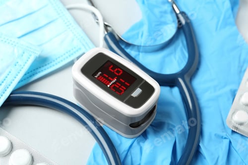 Preview: Modern fingertip pulse oximeter and medical items on white background, closeup
