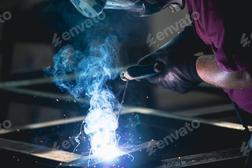 Preview: Industry worker welding iron pieces at work