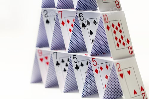 Preview: house of playing cards over white background