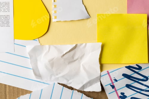 Preview: Ripped up pieces of notebooks, newspaper and coloured paper with copyspace on yellow background