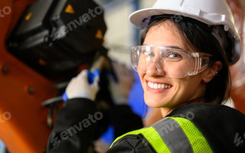 Preview: Professional maintenance worker with machine robotic arms at industrial factory
