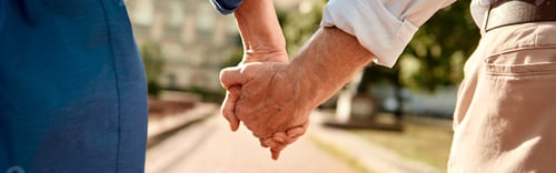Preview: You and me forever. Close-up of elderly couple holding hands while walking together outdoors