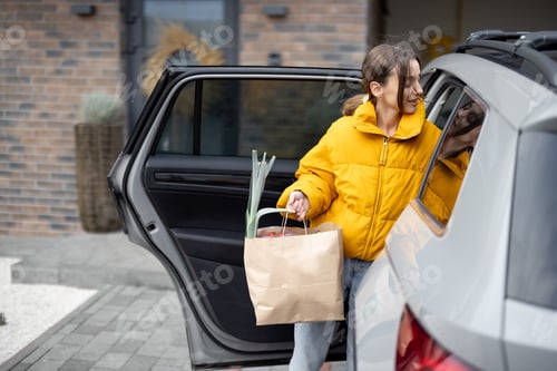 Preview: Woman arrives home with a groceries
