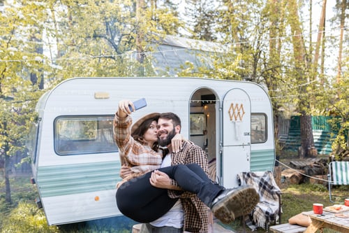 Preview: Affectionate Couple Taking a Selfie near Camper