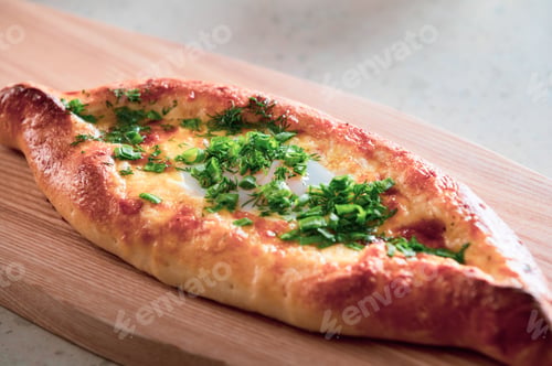 Preview: a pizza crust that looks like an egg sitting on a board