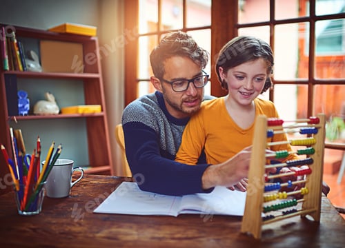 Preview: Shot of a father helping his little daughter with her homework