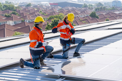 Preview: Engineer service check installation solar cell on the roof of factory.