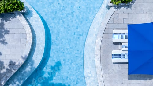 Preview: Top view swimming pool blue water in summer with umbrella.