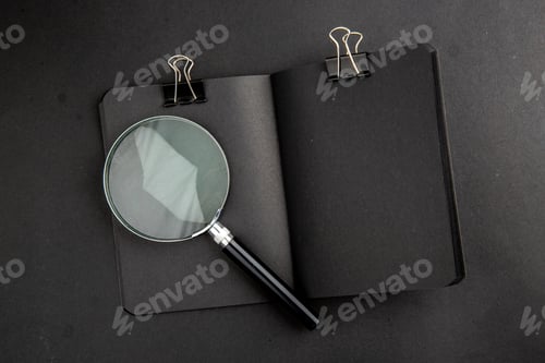 Preview: top view lack notepad binder clip lupa on black background