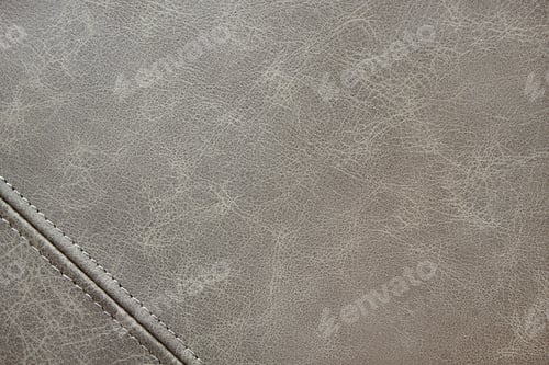 Preview: Texture gray leather with a decorative seam, closeup background