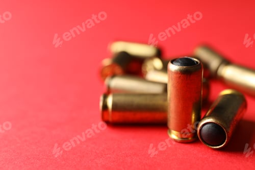 Preview: Rubber bullets on red background, close up