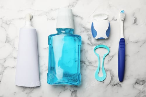 Preview: Flat lay composition with tongue cleaner and teeth care products on marble background