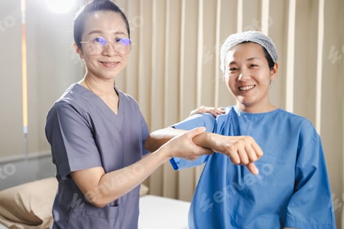 Preview: Woman Therapist Examining a Patient Arm in Hospital