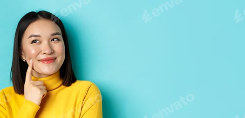 Preview: Beauty and makeup concept. Close up of pensive asian girl smiling, imaging something and looking at