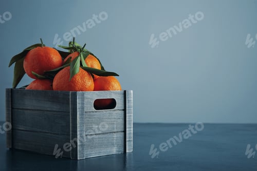 Preview: fresh tangerines in box with leaves isolated close