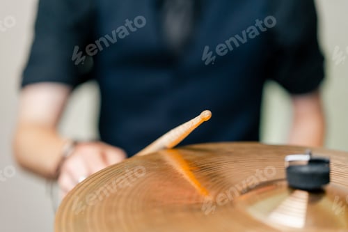 Preview: close-up musician during rehearsal plays drums musical instrument drumsticks music concert